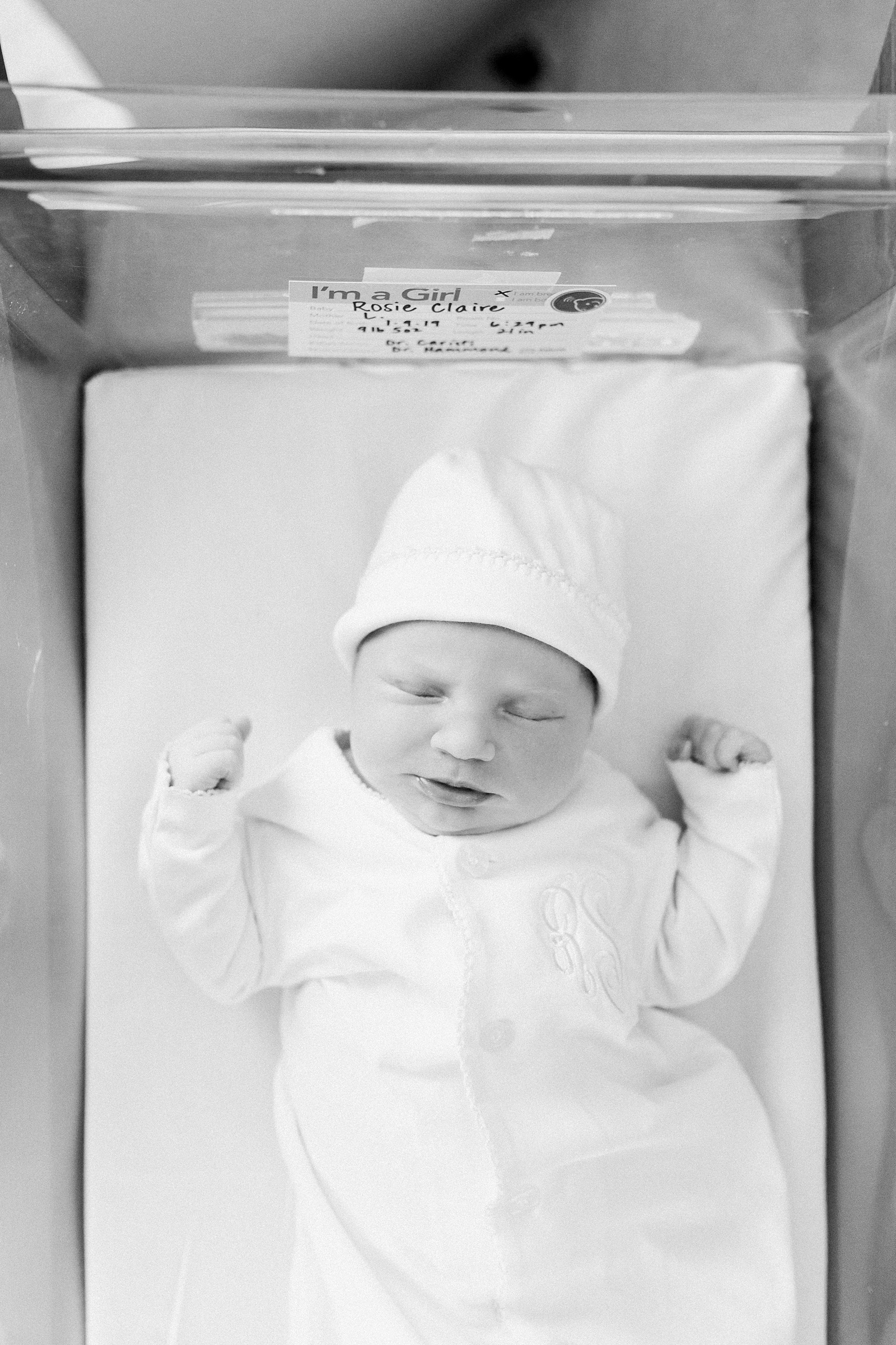 Black and white image of baby in hospital bassinet by Fresh 48 Photographer, Caitlyn Motycka Photography