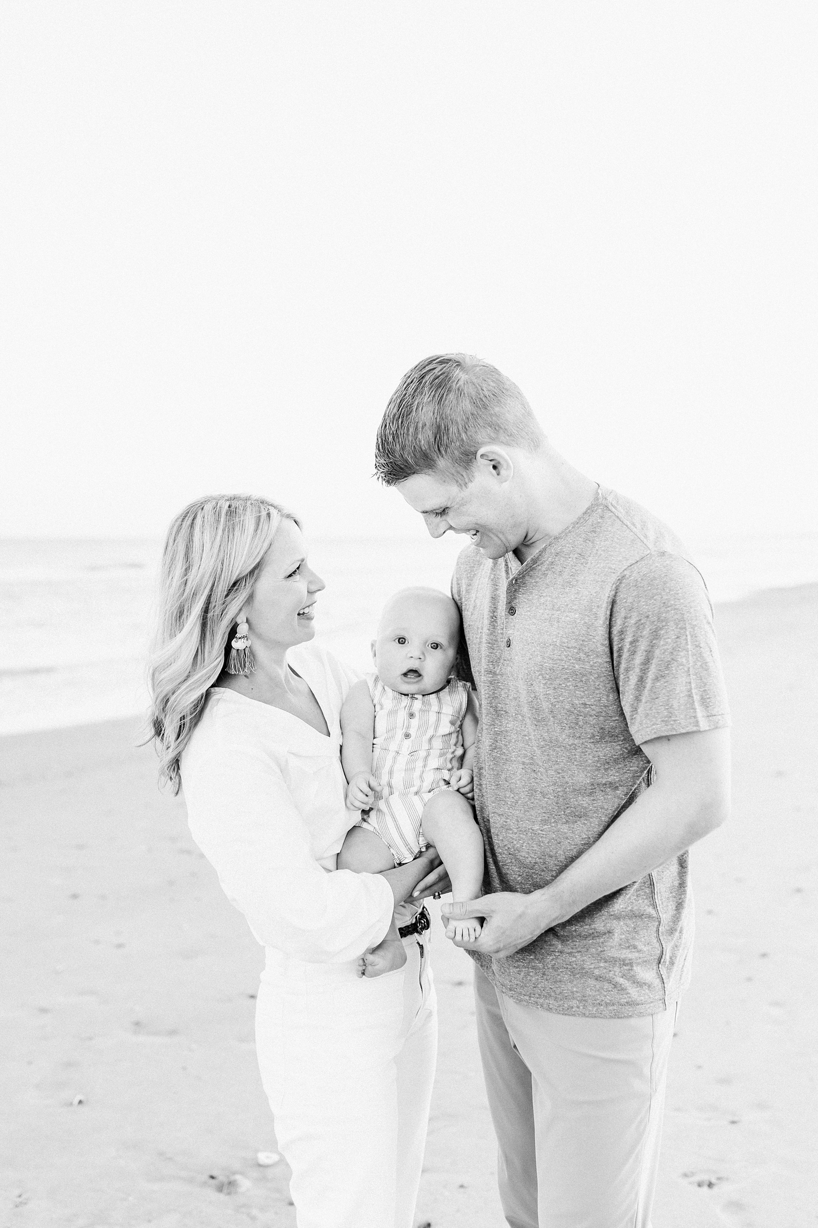 Black and white image of couple with baby boy on beach near Charleston, SC | Caitlyn Motycka Photography