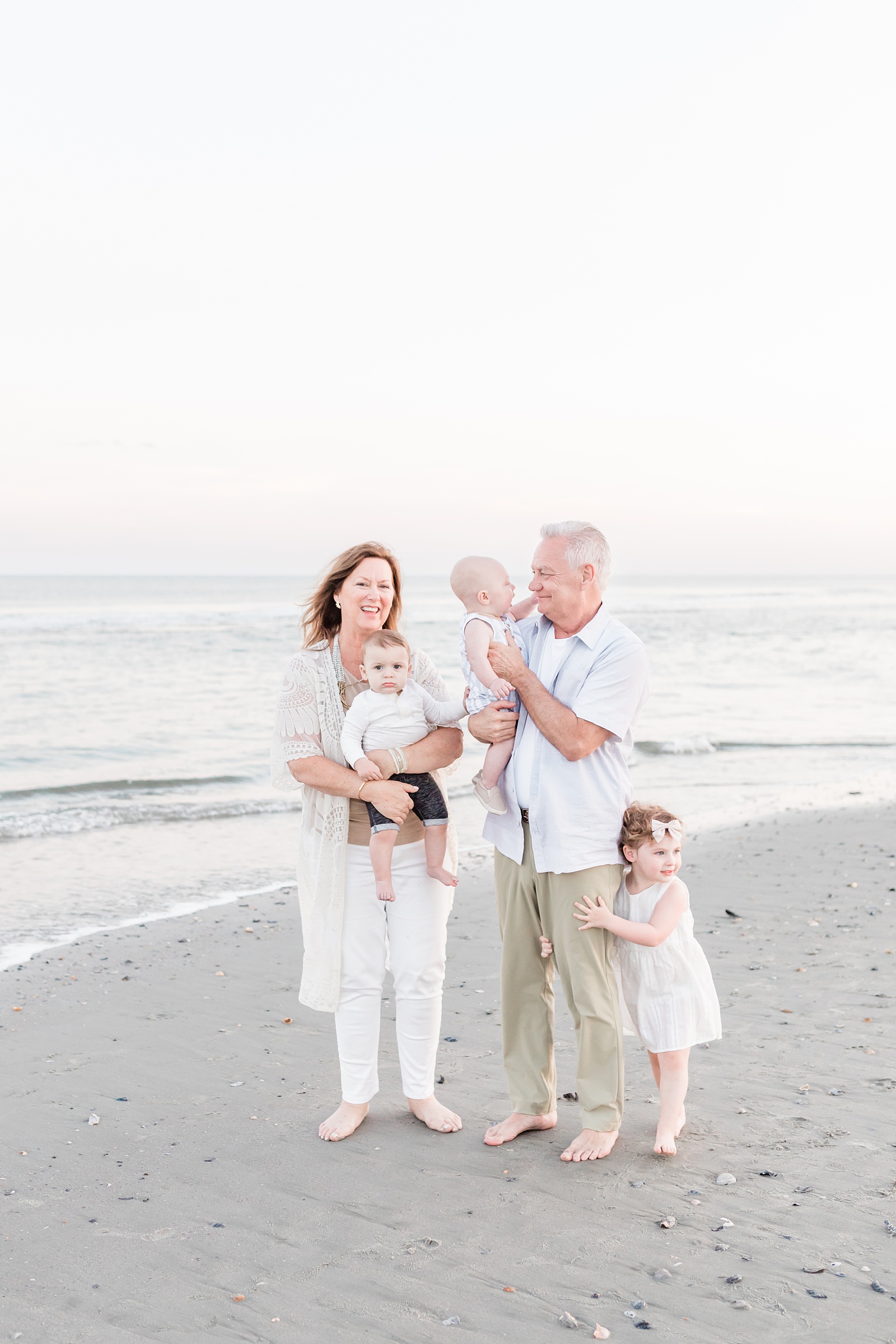 Grandparents on beach with grandchildren during family session by Charleston Family Photographer, Caitlyn Motycka Photography