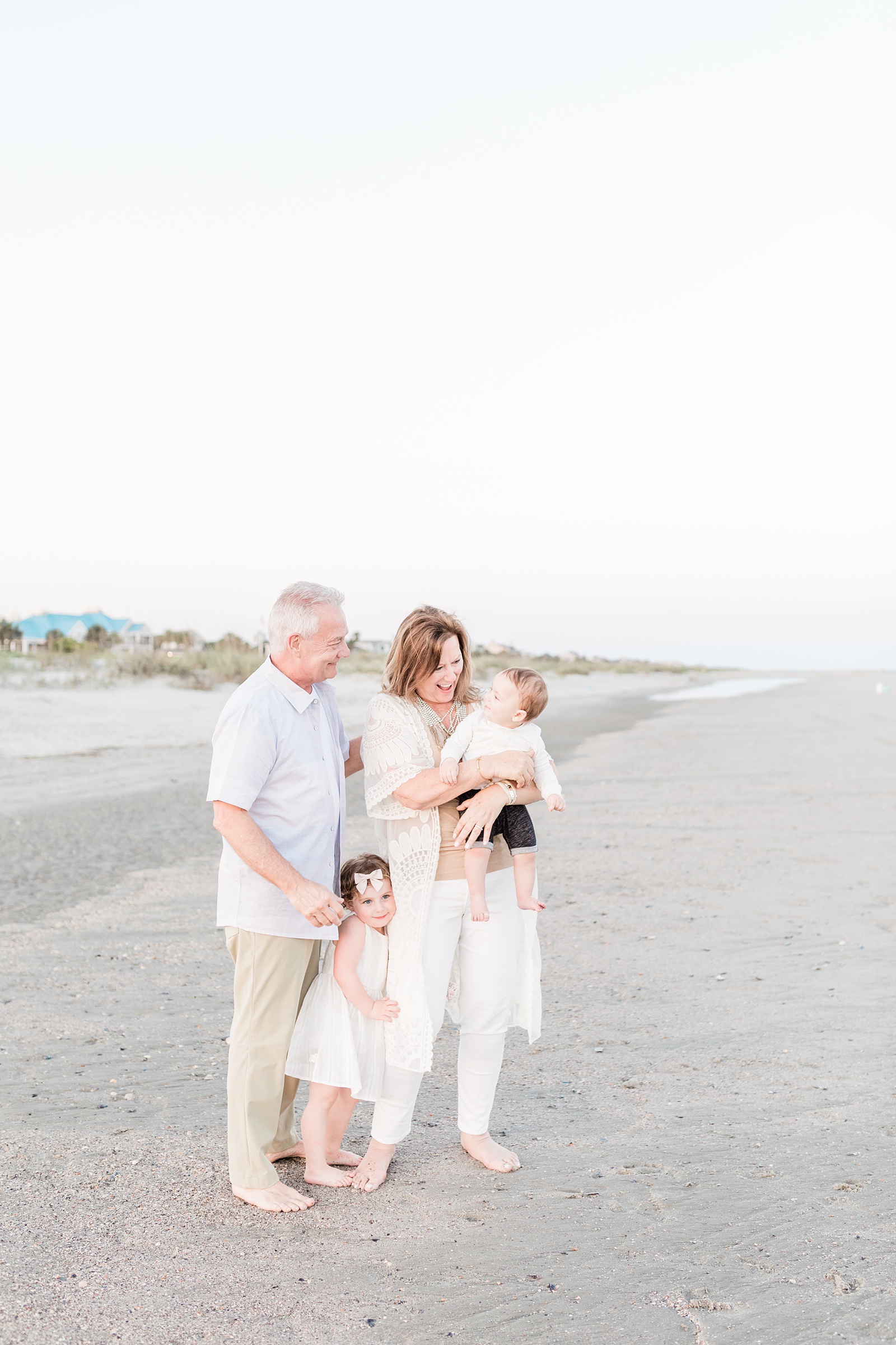 Grandparents with their grandkids on beach during extended family session by Charleston Family Photographer, Caitlyn Motycka Photography
