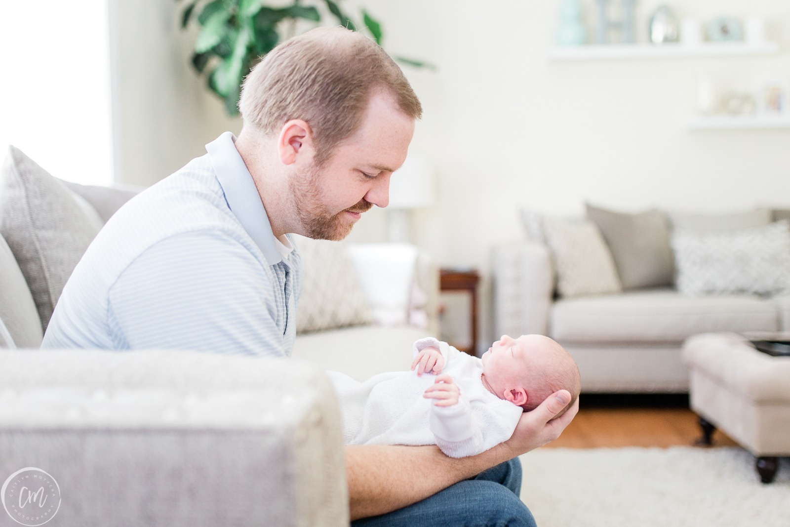 Dad and baby girl during lifestyle newborn session with Charleston Newborn Photographer, Caitlyn Motycka Photography