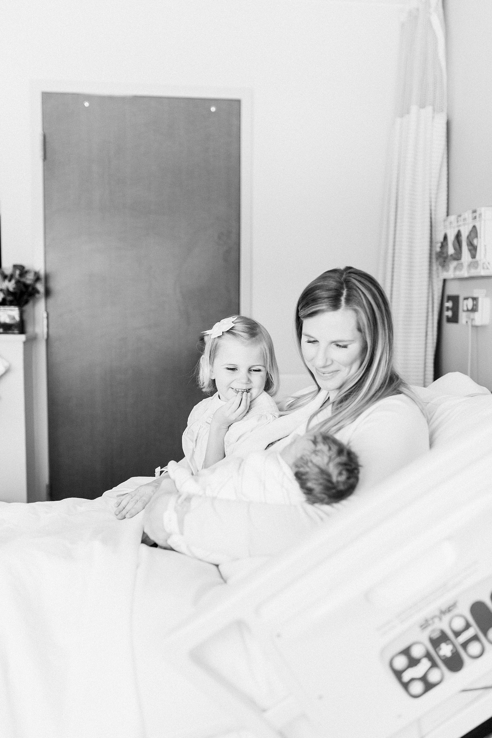 Older sibling meeting baby at hospital by Charleston Fresh 48 photographer, Caitlyn Motycka Photography