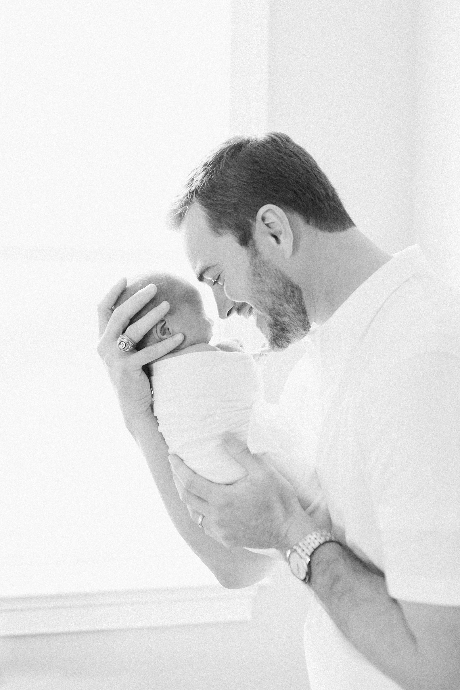 Black and white image of dad with baby by Charleston newborn photographer, Caitlyn Motycka Photography