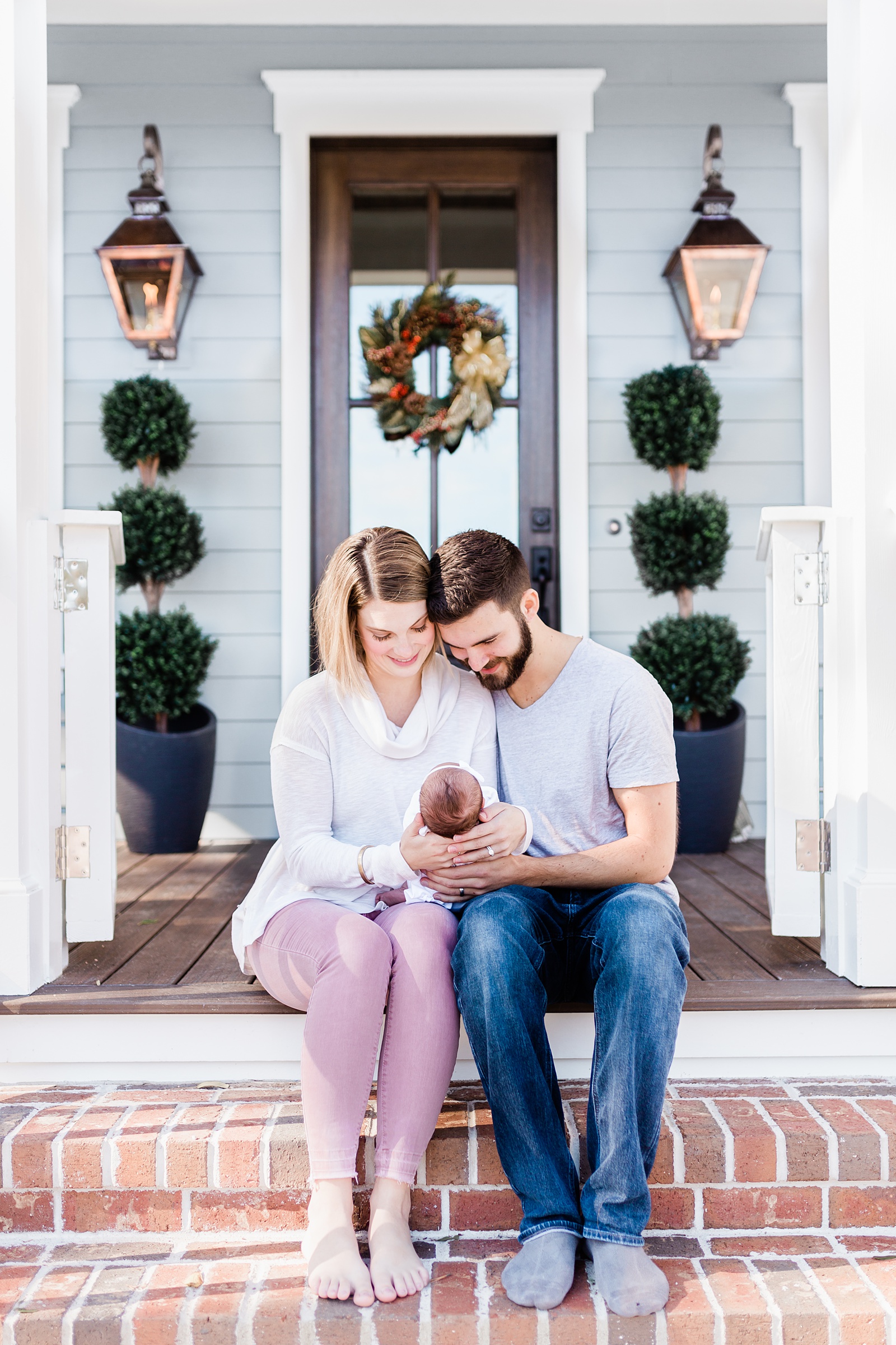 Family on front porch during lifestyle newborn session in Mount Pleasant, SC | Caitlyn Motycka Photography