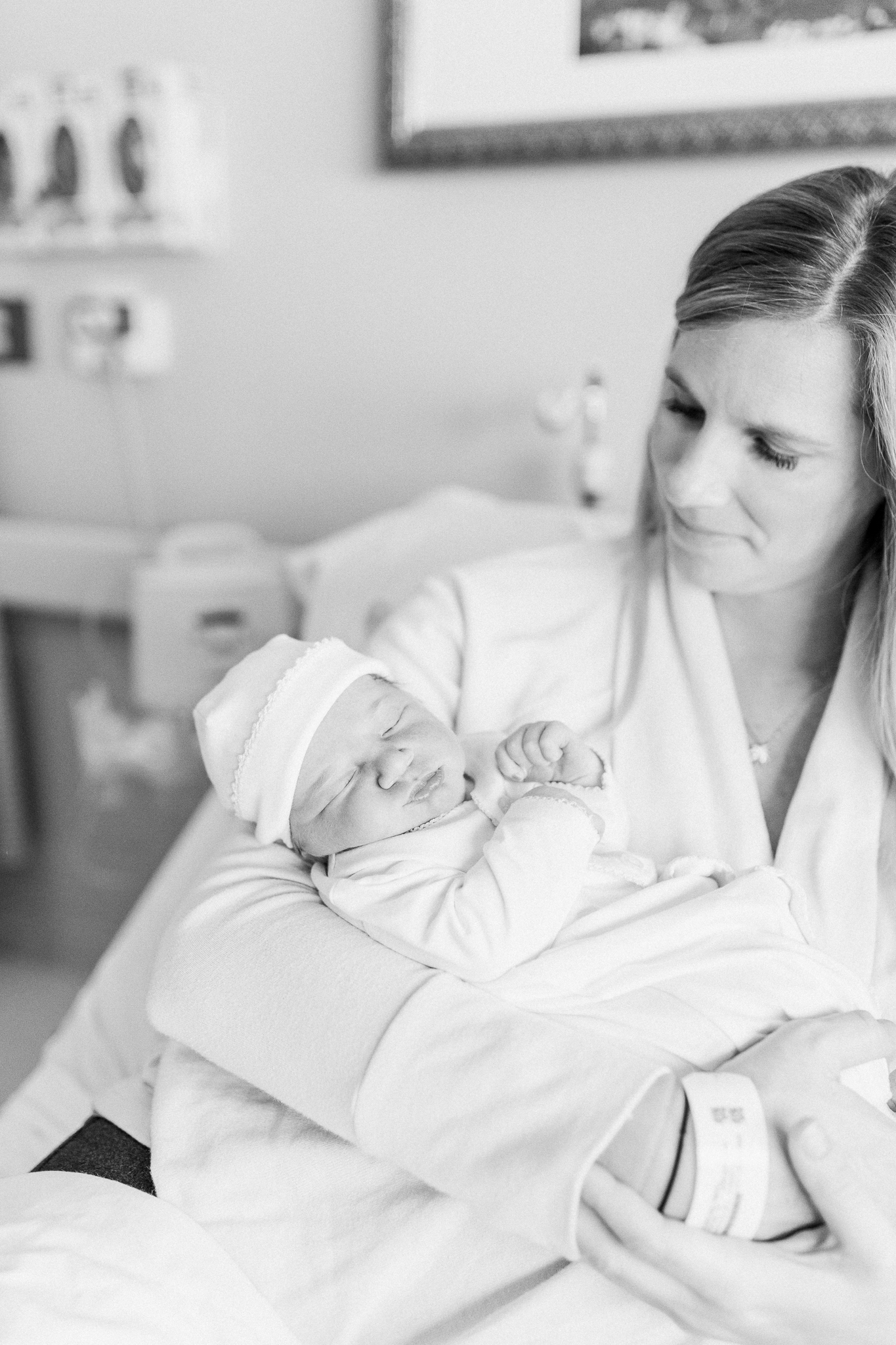 Mom holding baby with squished cheeks by Charleston newborn photographer, Caitlyn Motycka Photography 