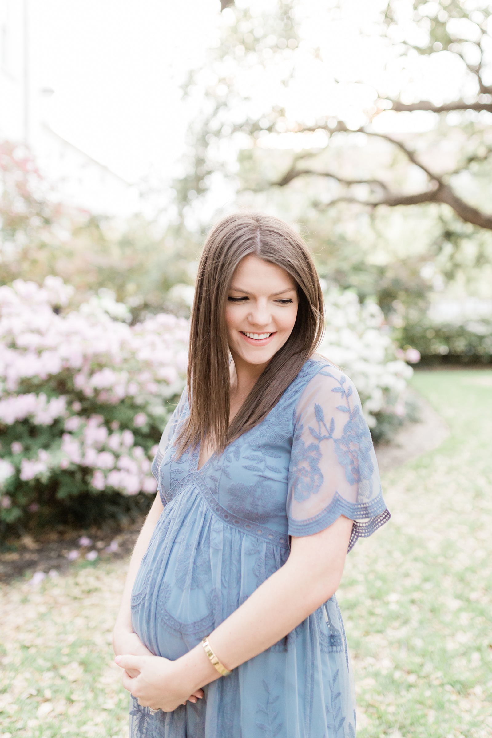 Gorgeous mom in blue lace maternity dress during maternity session in Charleston, SC by Caitlyn Motycka Photography