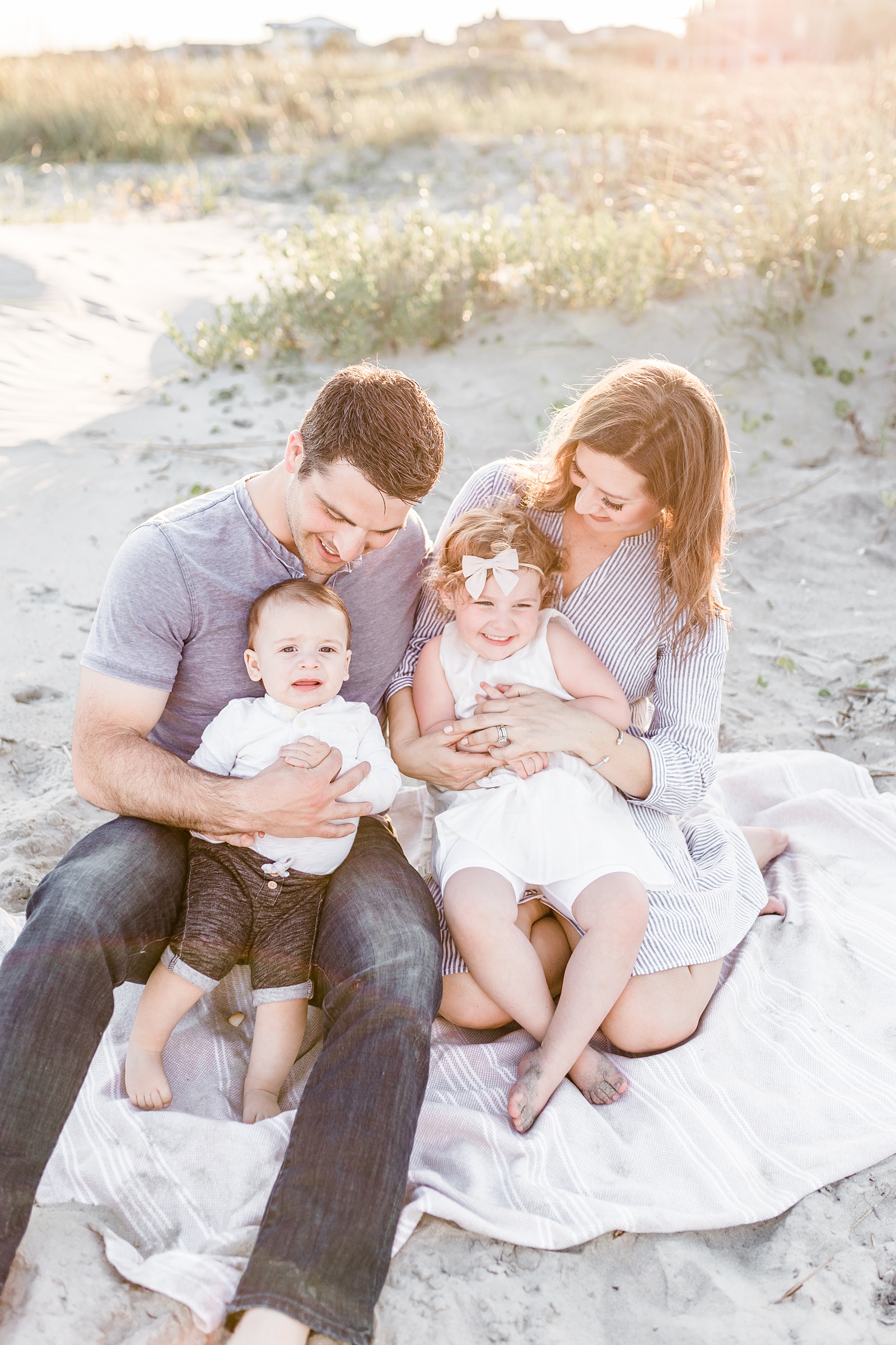 Family on blanket at Isle of Palms beach outside of Charleston, SC | Caitlyn Motycka Photography