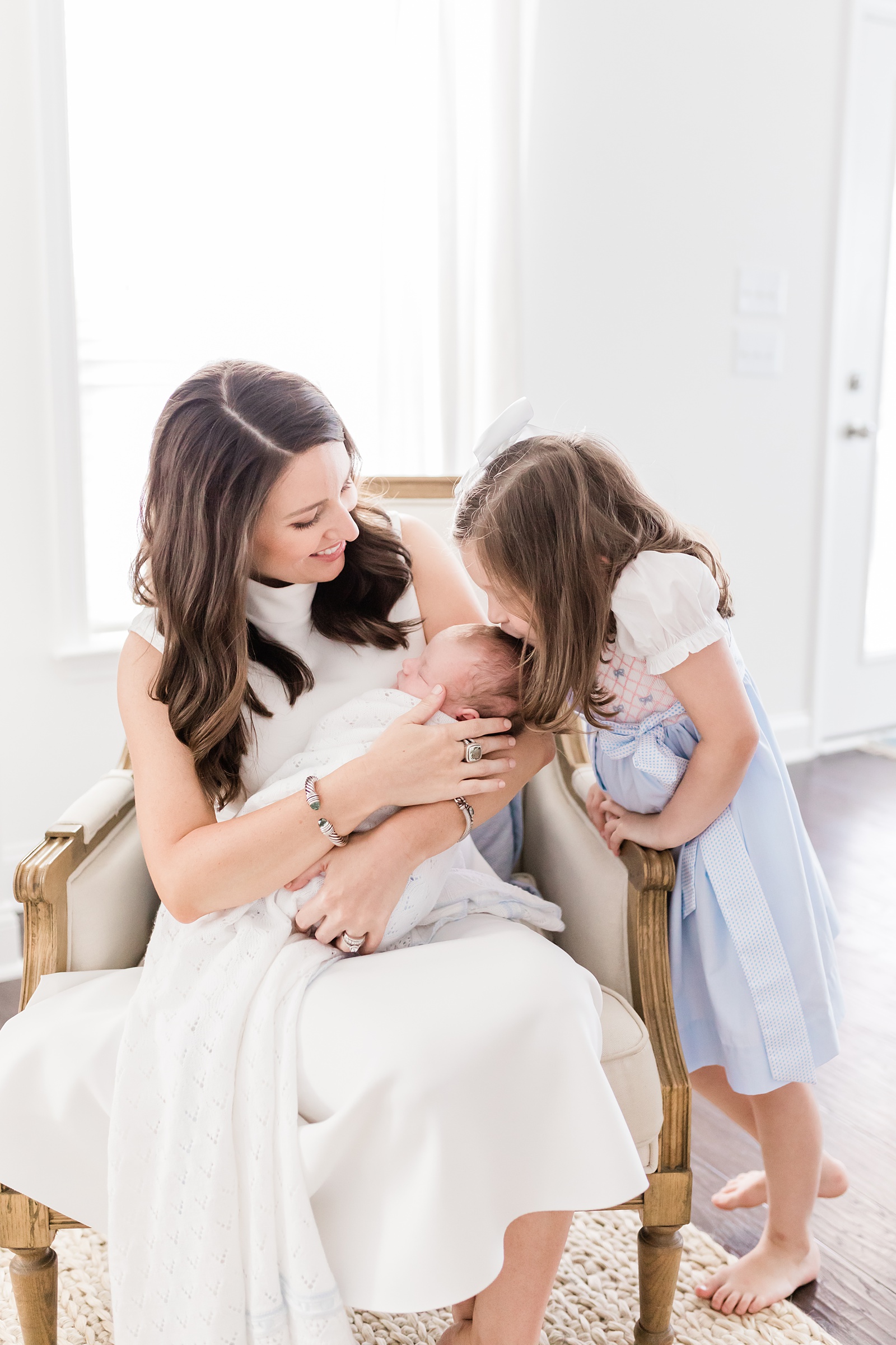 Mom with baby boy and big sister during lifestyle newborn session | Caitlyn Motycka Photography