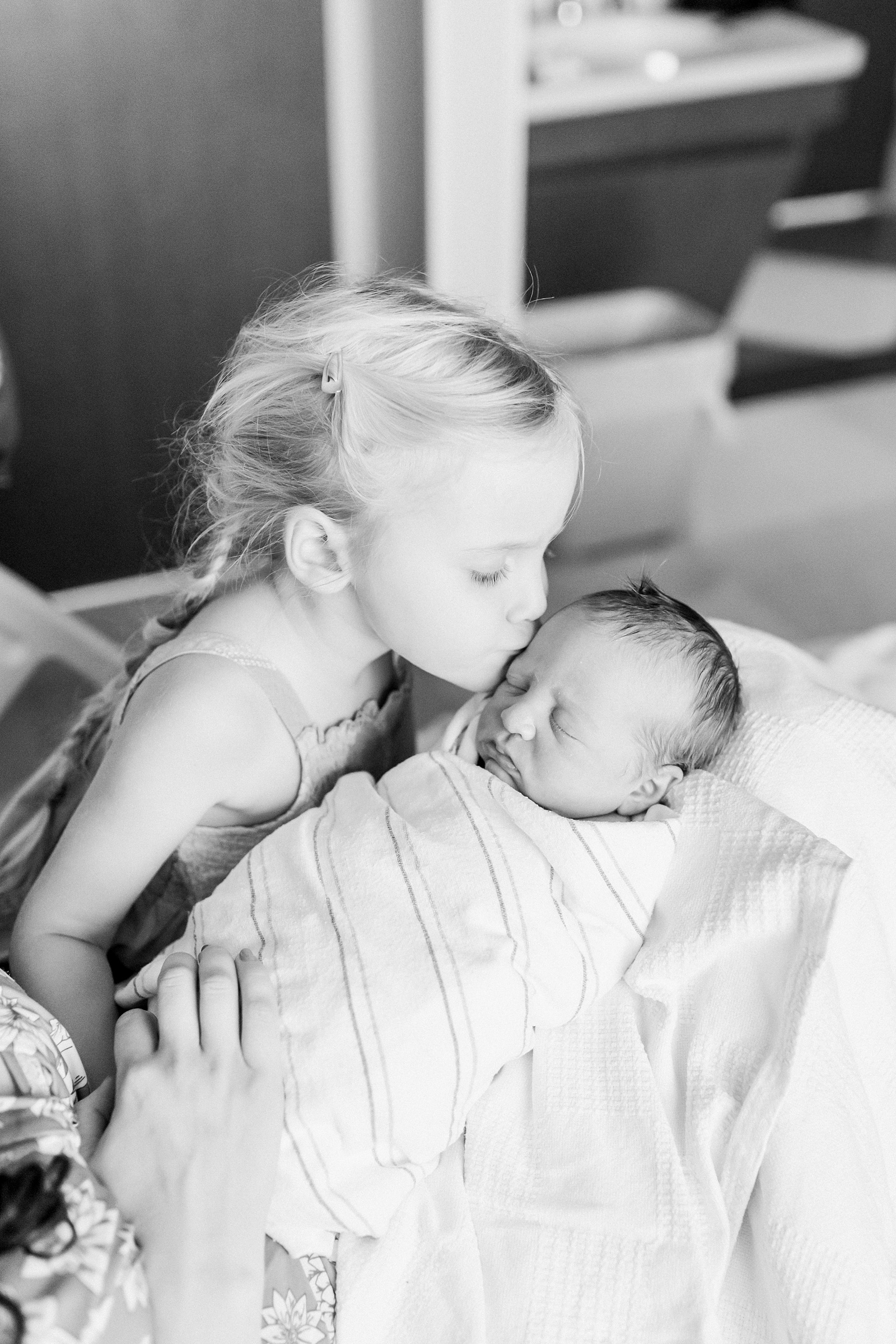 Sibling kidding baby during Fresh 48 session | Caitlyn Motycka Photography
