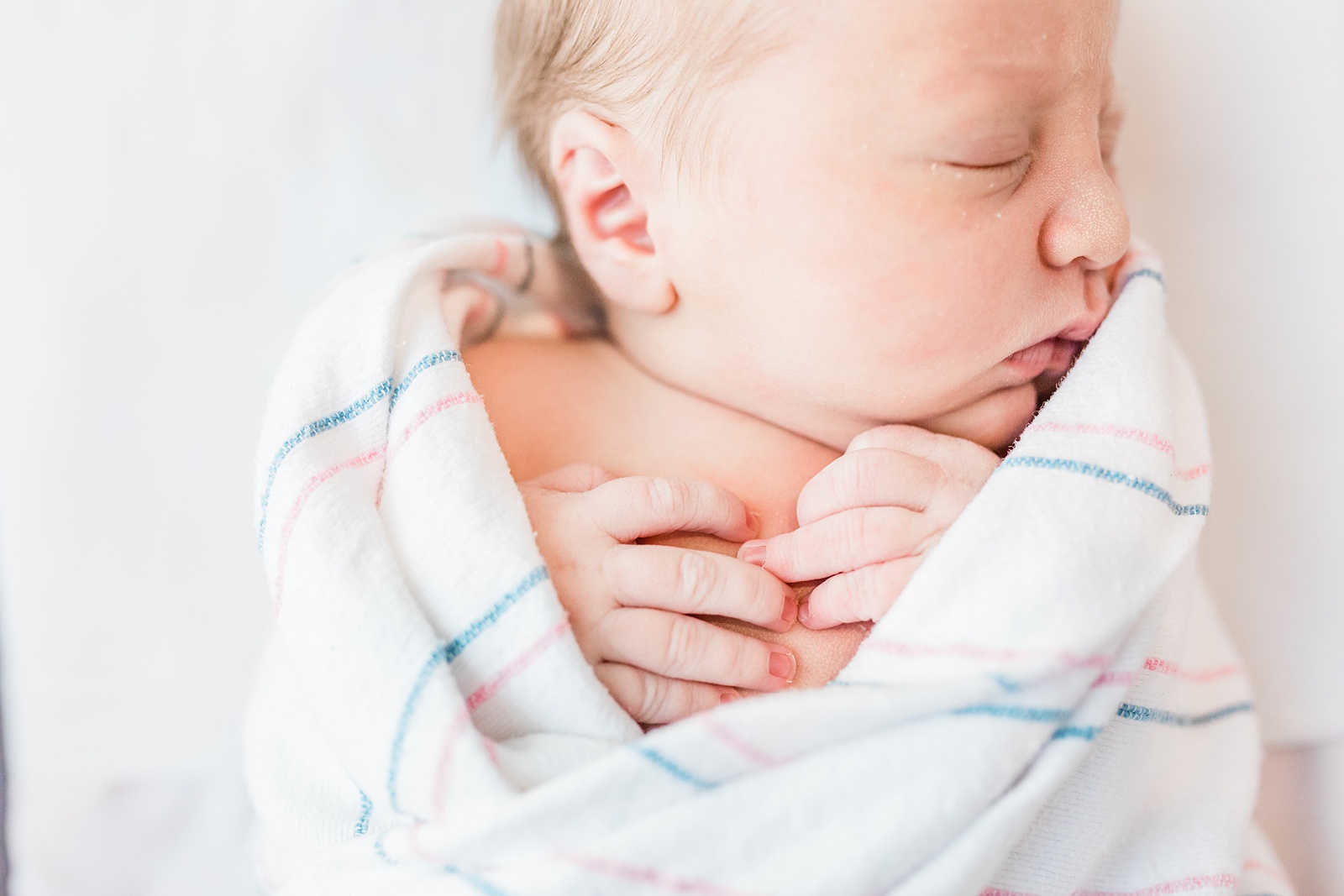 Close up details of newborn with hospital blanket by Caitlyn Motycka Photography