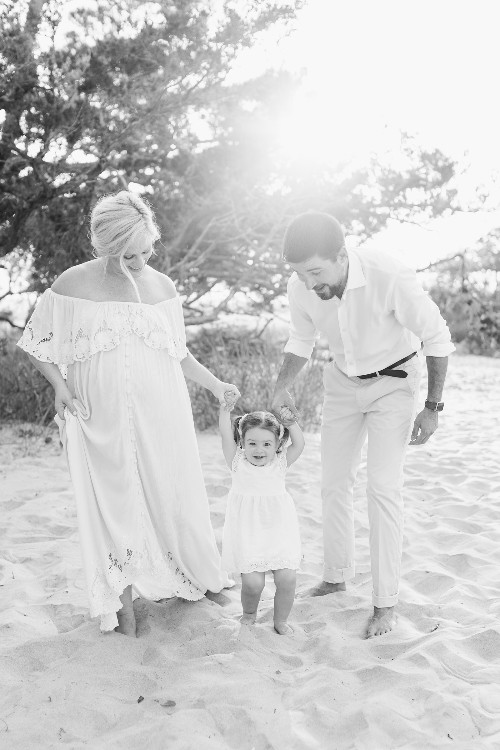 Black and white image from maternity session with toddler on Folly Beach by Caitlyn Motycka Photography