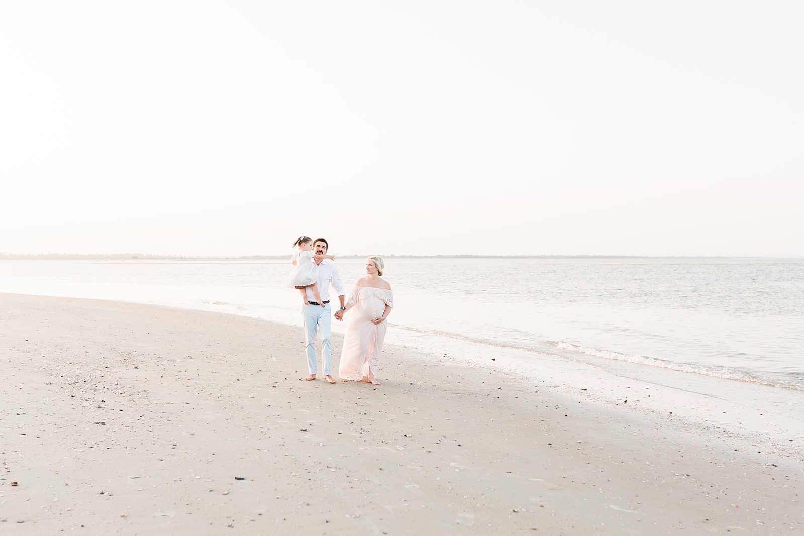 Family on Folly Beach during maternity session by Caitlyn Motycka Photography