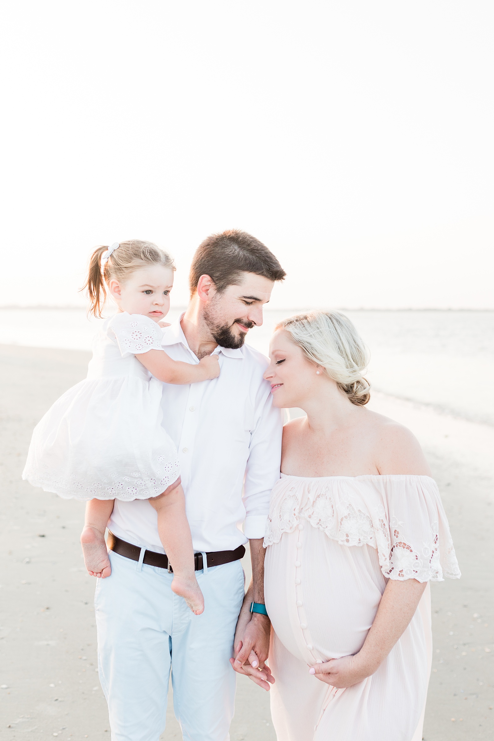 Family with toddler during beach maternity session by Charleston Maternity Photographer, Caitlyn Motycka Photography