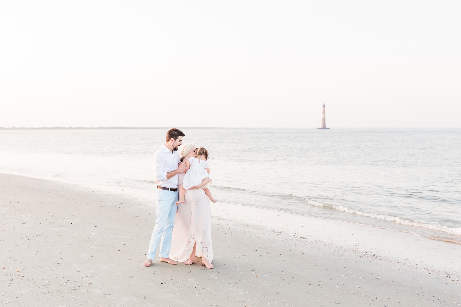Family walking on Folly Beach during maternity session by Caitlyn Motycka Photography