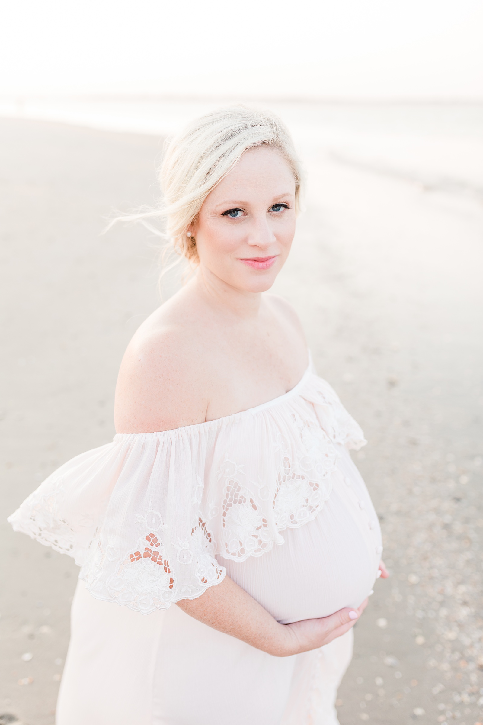 Mom in blush maternity dress on Folly Beach by Charleston Family Photographer, Caitlyn Motycka Photography