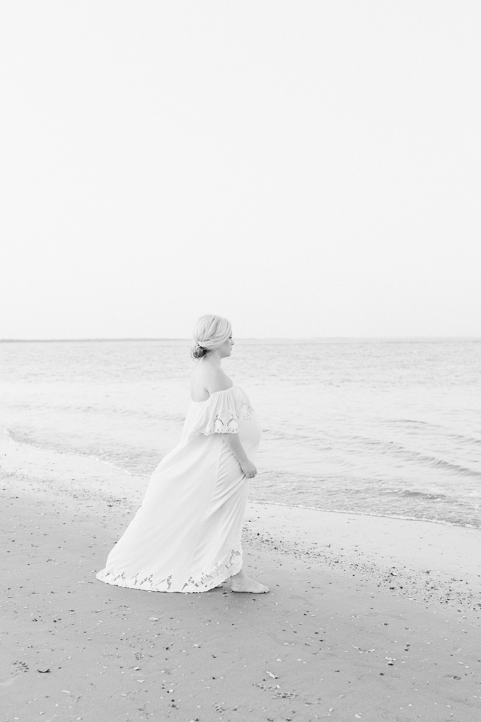 Black and white beach maternity photo with lace maxi dress by Caitlyn Motycka Photography