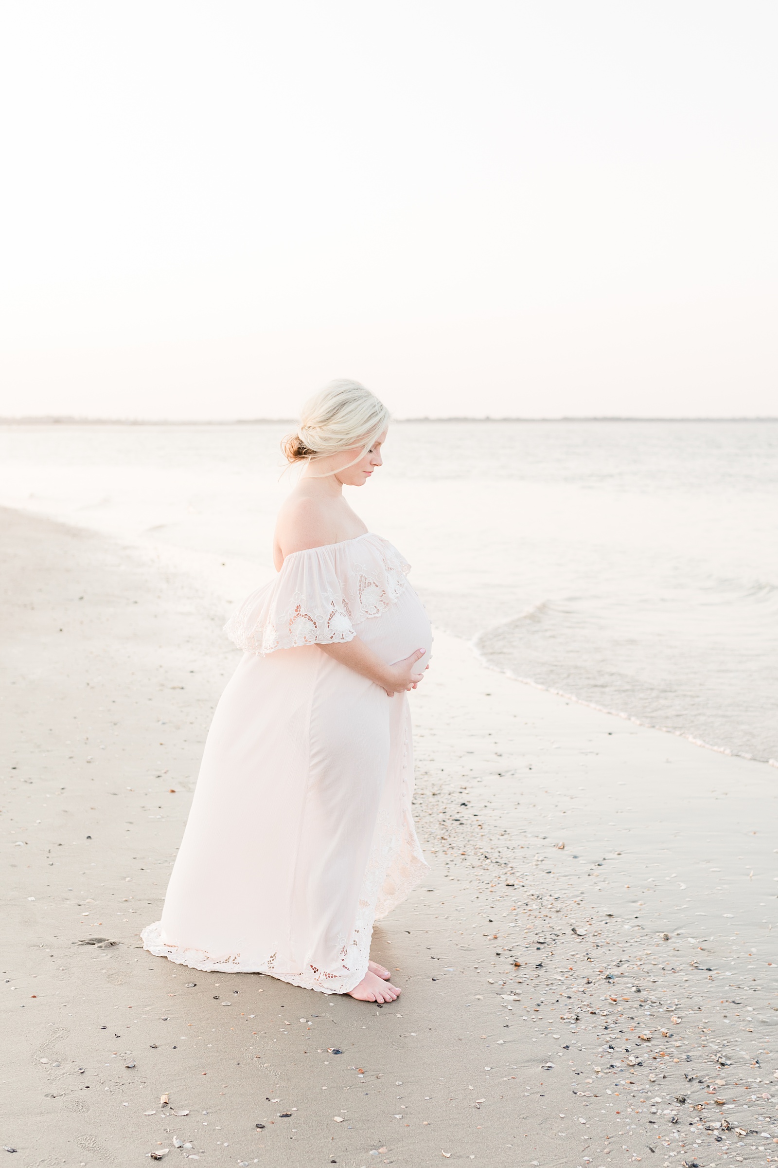 Mom in lace maxi dress during maternity session on Folly Beach by Caitlyn Motycka Photography