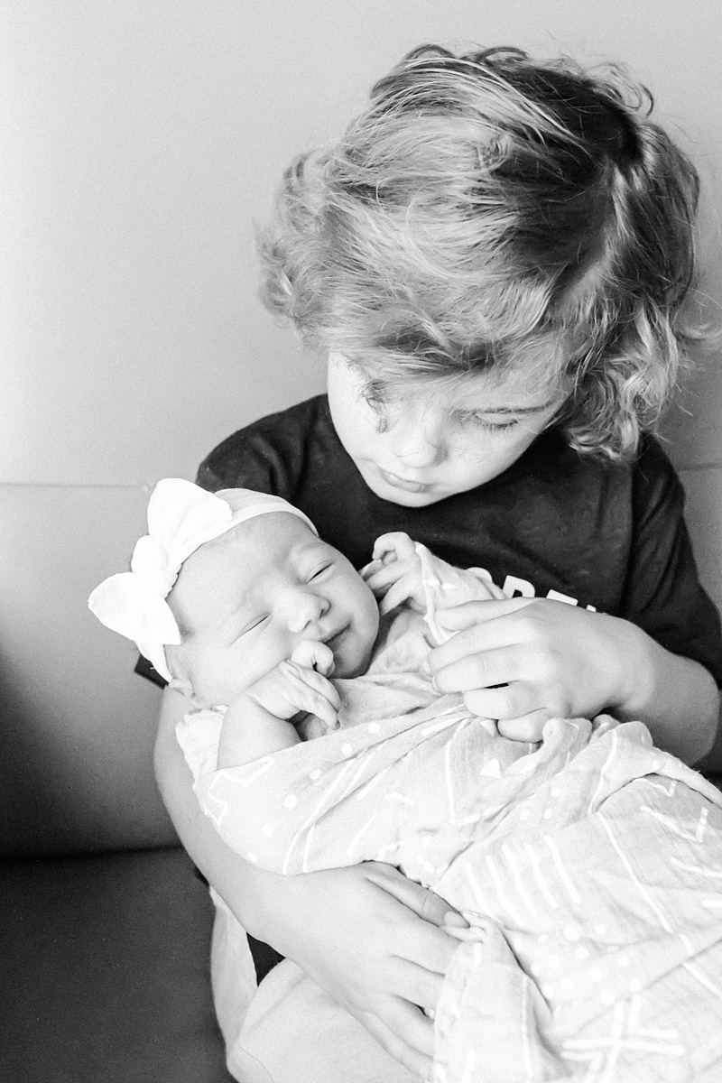 Big brother holding his baby sister at Fresh 48 session. Photos by Caitlyn Motycka Photography.