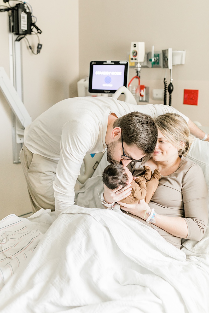 Daddy kissing baby boy at Fresh 48 hospital session | Caitlyn Motycka Photography