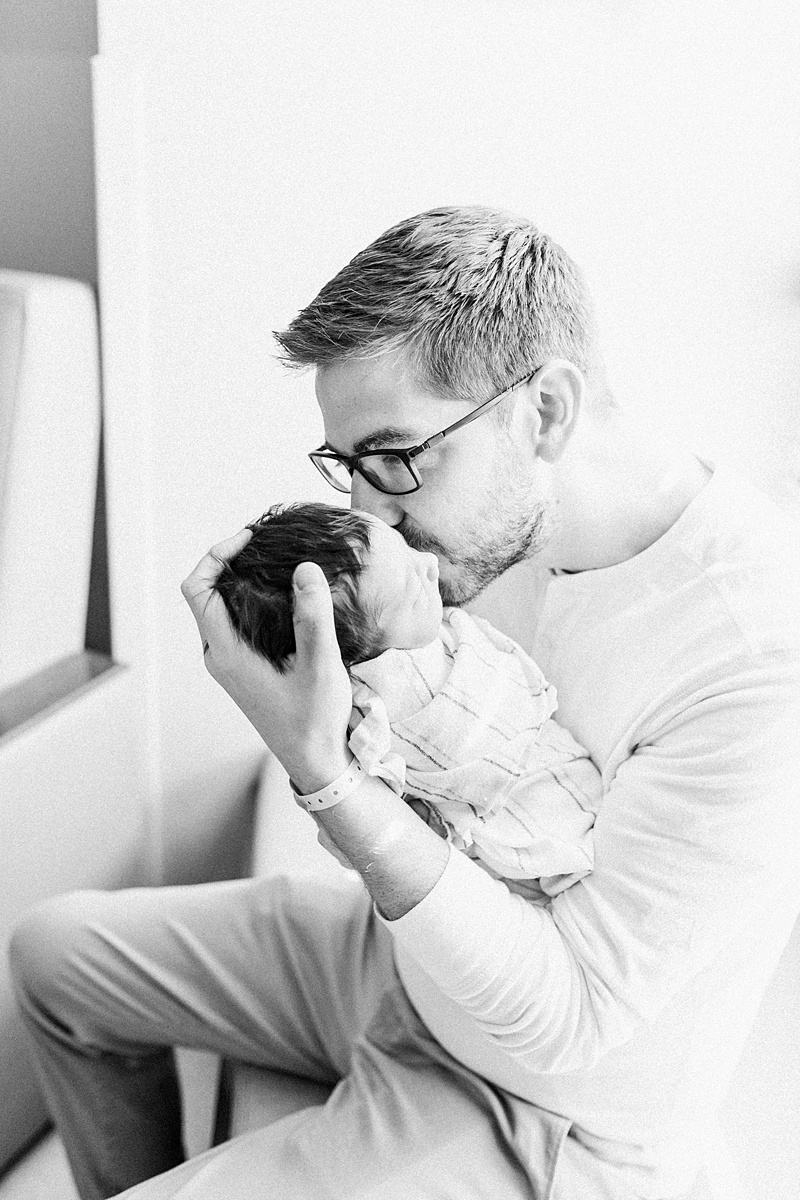 Black and white photo of Daddy and son at Fresh 48 Hospital session | Caitlyn Motycka Photography