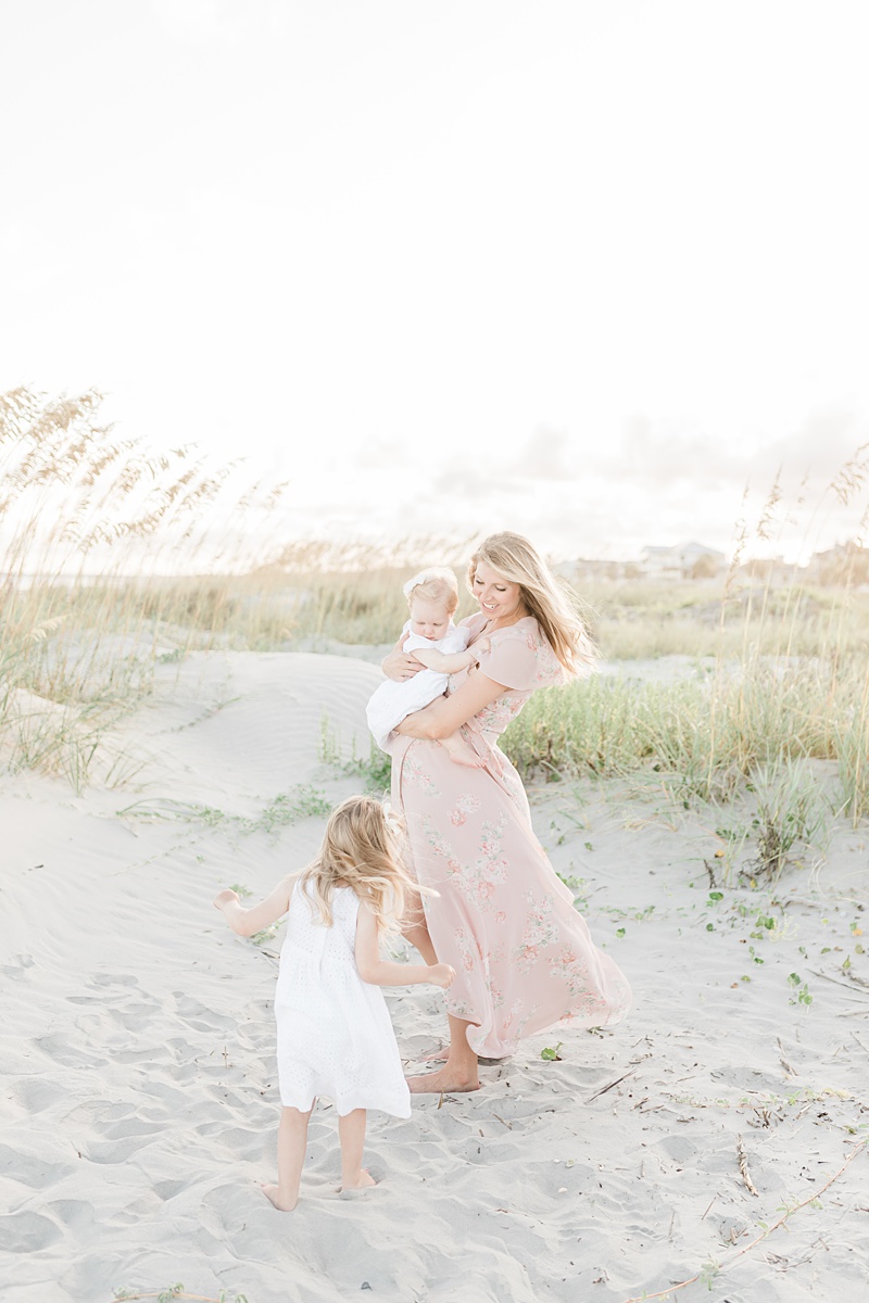 Mama and her girls during a maternity session at Isle of Palms beach in Charleston, SC. Photos by Charleston Maternity and Newborn Photographer, Caitlyn Motycka Photography. 
