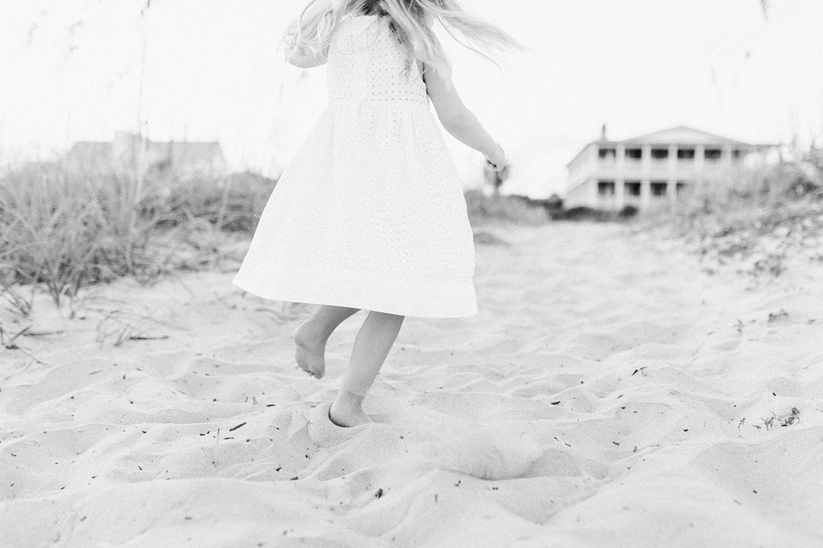  Little girl dancing on the beach at Isle of Palms beach family session | Caitlyn Motycka Photography