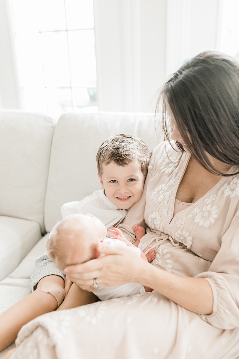 Mama and her boys during lifestyle newborn session in their home. Photographed by Charleston Newborn Photographer, Caitlyn Motycka Photography. 