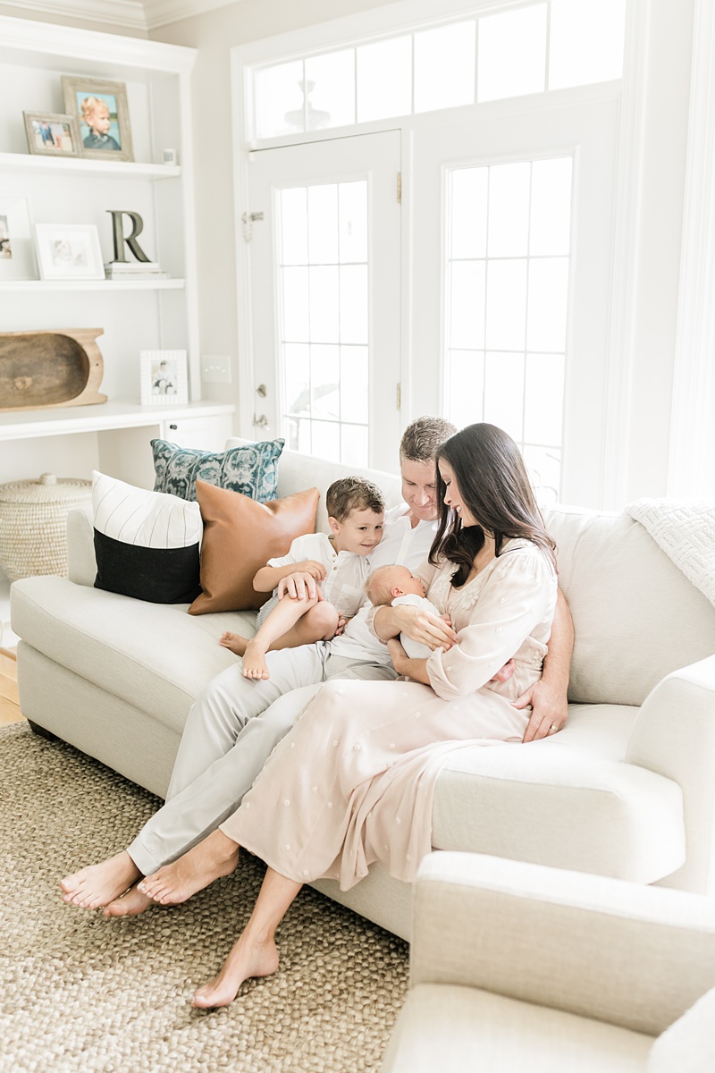 Mama and Daddy with their boys during lifestyle newborn session in their home. Photographed by Charleston Newborn Photographer, Caitlyn Motycka Photography. 