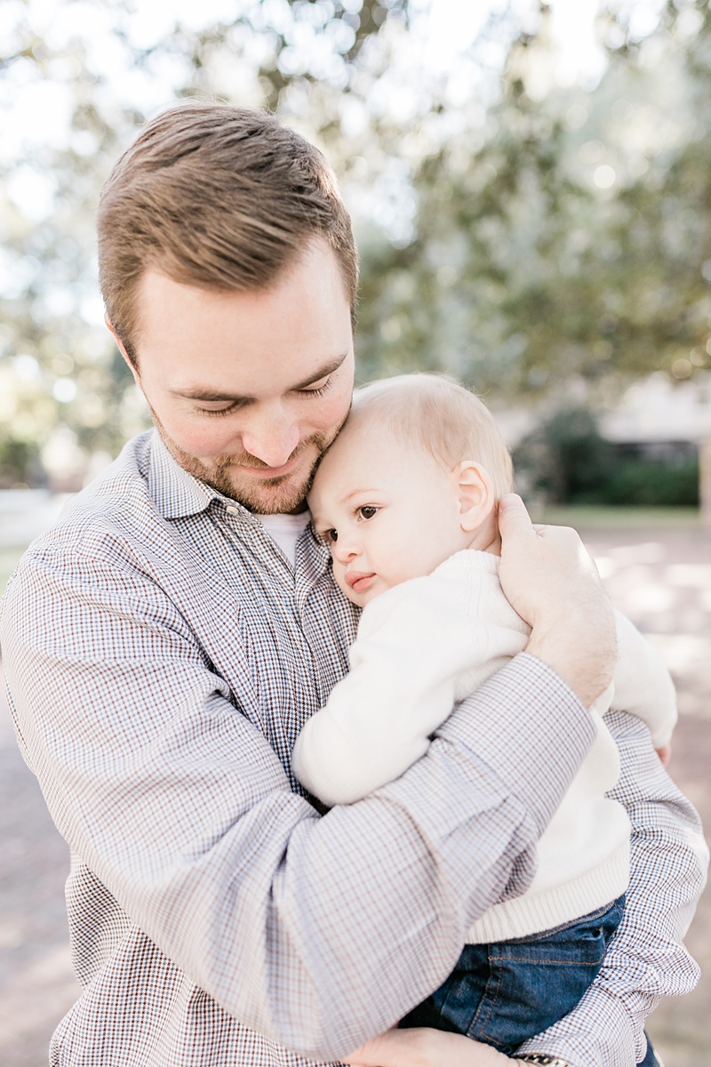 Daddy snuggling his son during first birthday photoshoot. Photos by Charleston Family Photographer, Caitlyn Motycka Photography.