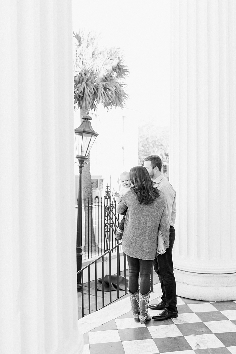 Black and white photo of family moment during photoshoot in Charleston. Photos by Charleston Family Photographer, Caitlyn Motycka Photography.