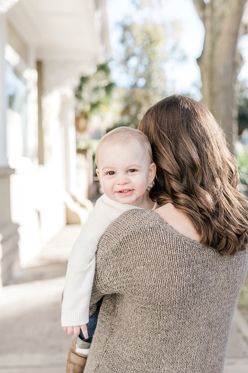 One year old smiling for his first birthday photos with Charleston Family Photographer, Caitlyn Motycka Photography.