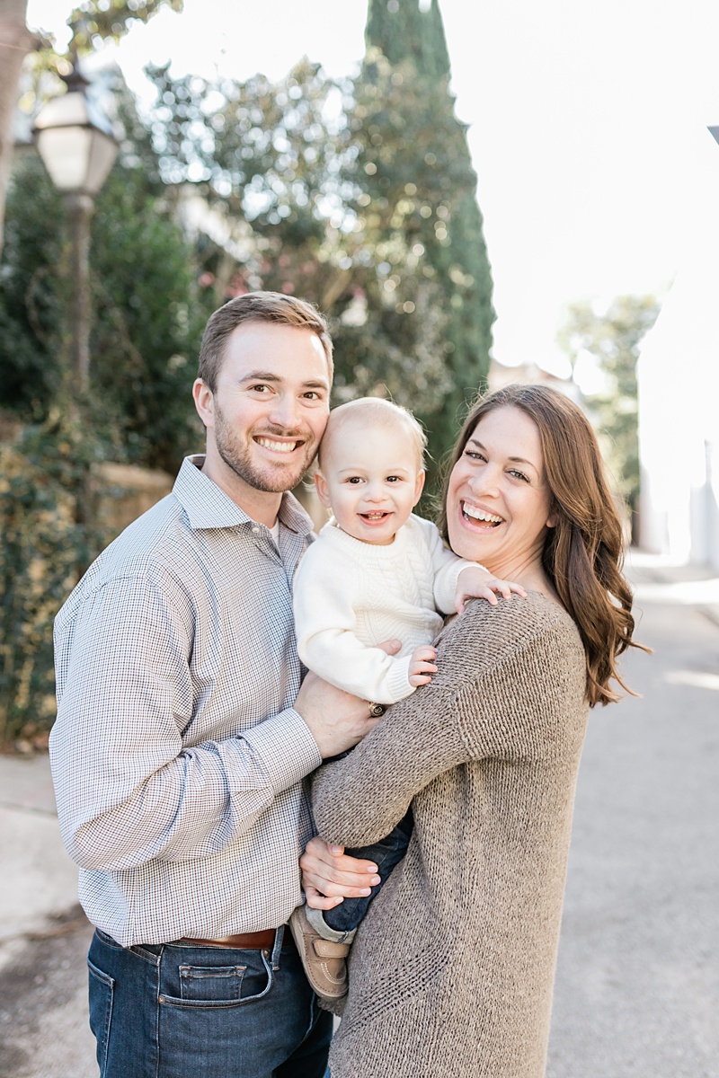 Family laughing together during photoshoot to celebrate little boy turning one. Photos by Charleston Family Photographer, Caitlyn Motycka Photography.