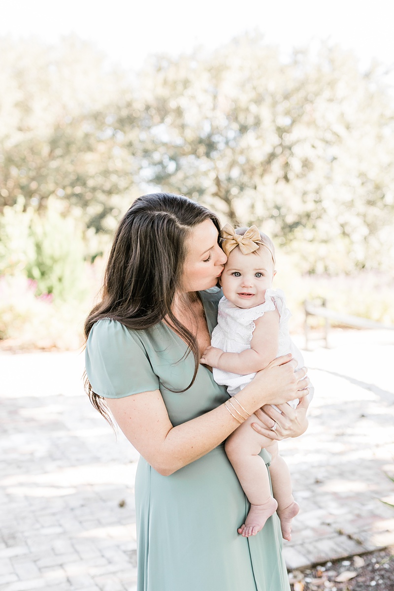 Mama giving her baby girl a kiss during motherhood photoshoot with Charleston Photographer, Caitlyn Motycka Photography.