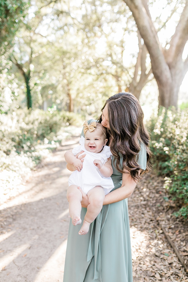 Mama and baby girl laughing and having a sweet moment together at photoshoot with Charleston Family Photographer, Caitlyn Motycka Photography.