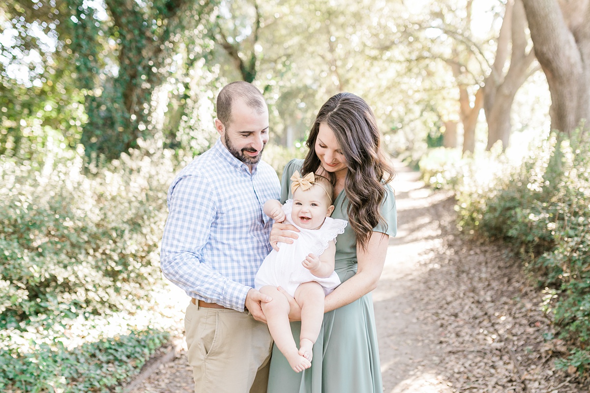 Baby girl laughing during family photos at Hampton Park with Charleston Photographer, Caitlyn Motycka Photography.