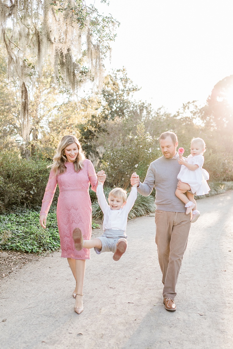 Family walks through the park in Charleston, SC for family photoshoot with Caitlyn Motcyka Photography. 
