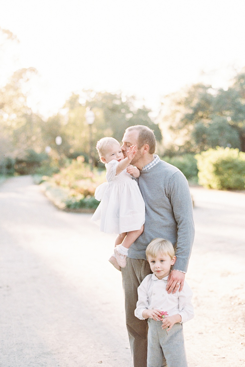 Daddy with two kids at sunset photoshoot with Charleston Family Photographer, Caitlyn Motycka Photography. 