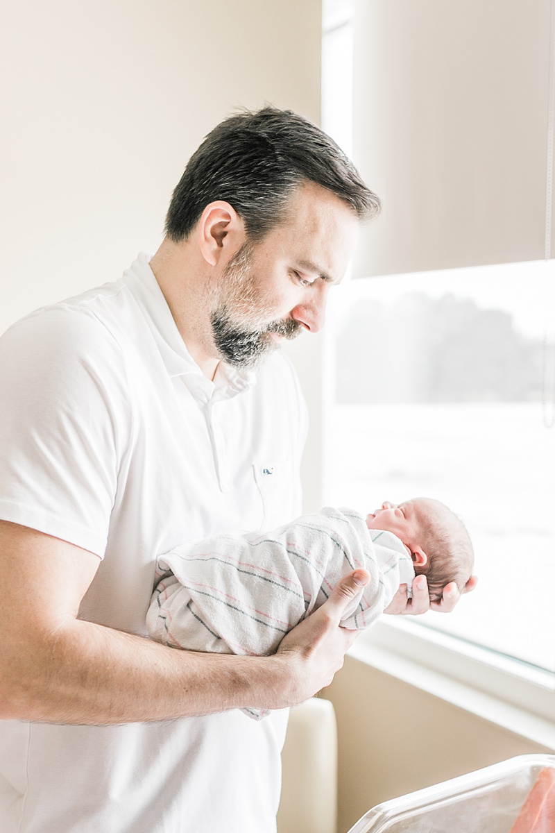 Daddy with baby girl during hospital newborn photoshoot at East Cooper Medical Center in Charleston, SC. Photos by Caitlyn Motycka Photography.