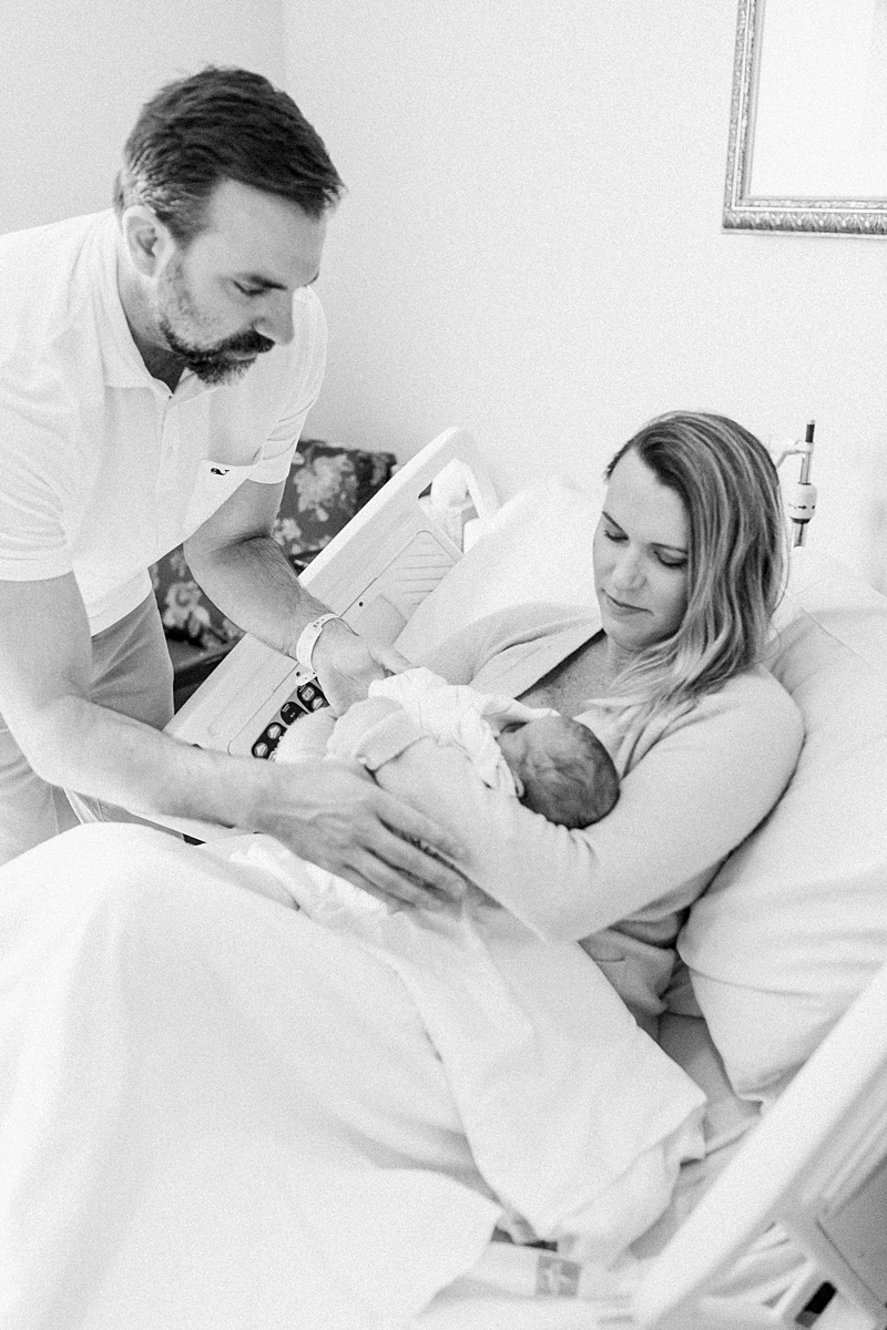 New parents with baby girl during hospital newborn photoshoot | Caitlyn Motycka Photography