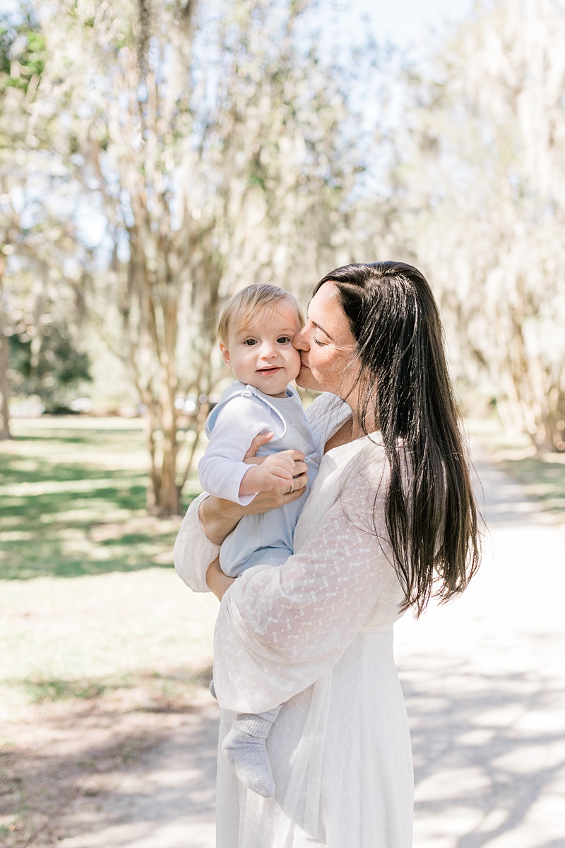 Mama and her second baby boy share a sweet moment during family photoshoot at Hampton Park | Caitlyn Motycka Photography