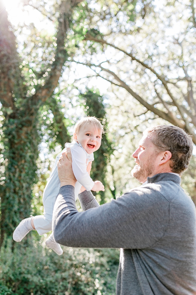 Father lifts son up at Fall mini session at Hampton Park | Caitlyn Motycka Photography