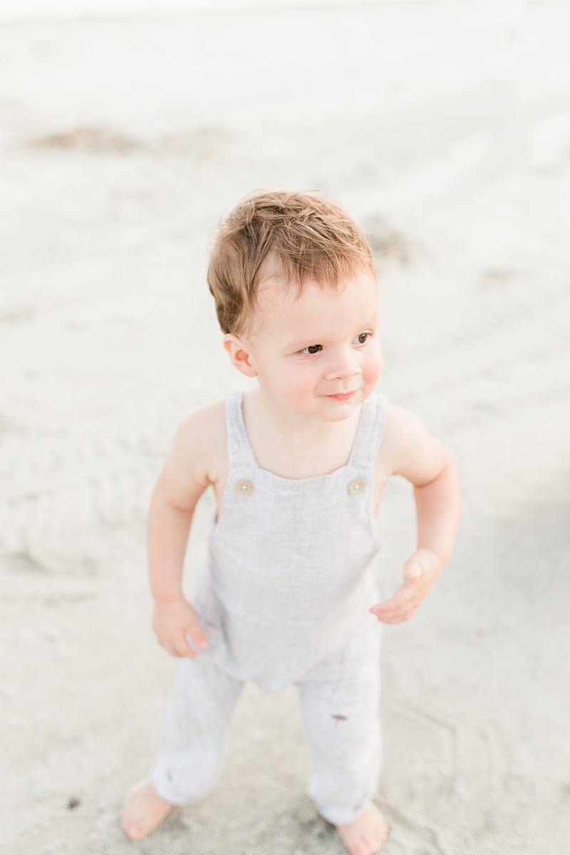 Cute toddler in Romper during beach family Session by Caitlyn Motycka Photography