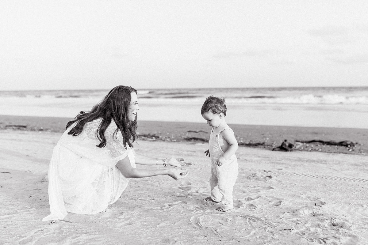 Black and white photo of mom and toddler on Isle of Palms beach by Caitlyn Motycka Photography