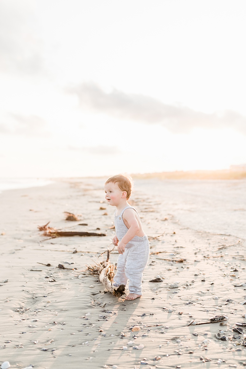 Toddler in romper at sunset on beach by Charleston Family Photographer, Caitlyn Motycka Photography