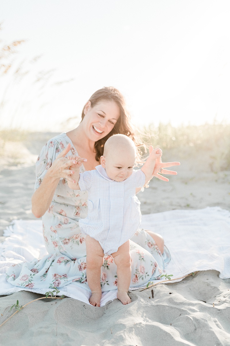 Six month old baby boy standing with Mama during beach photoshoot in Charleston, SC | Caitlyn Motycka Photography 