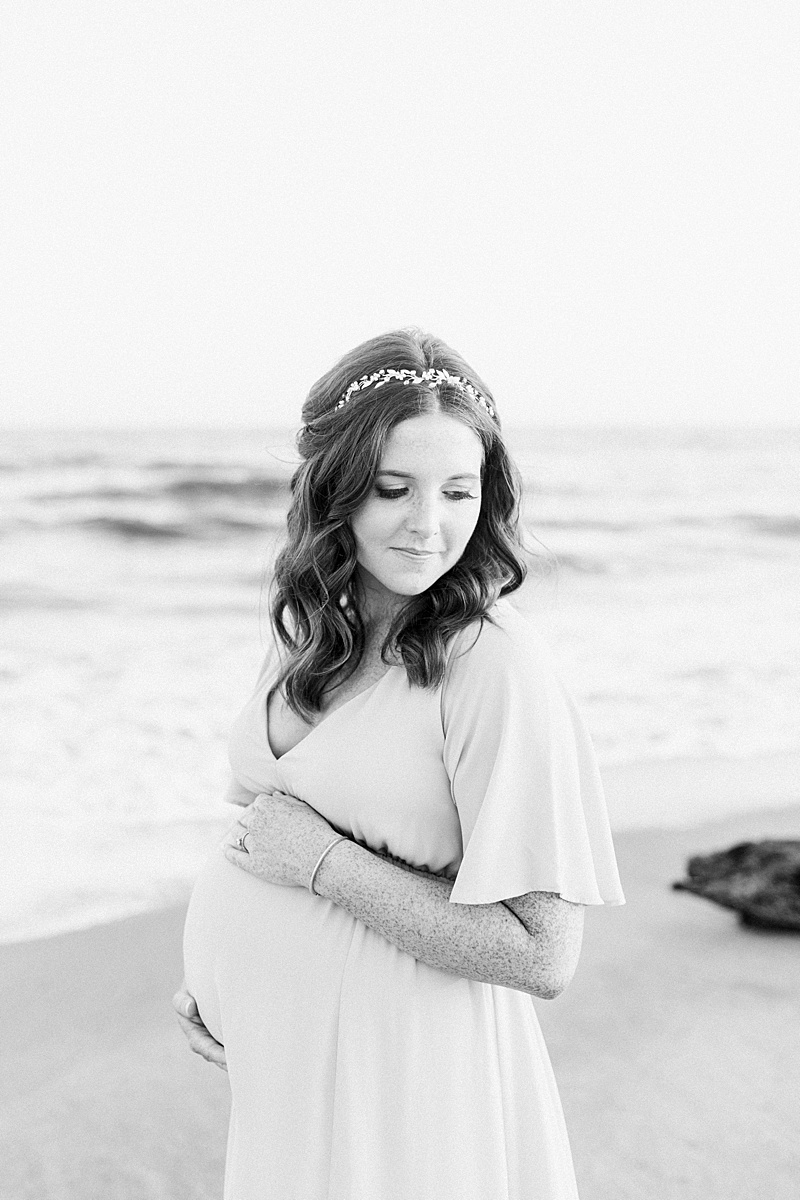 Black and white maternity photo of mama on the beach. Photos by Charleston Maternity and Newborn Photographer, Caitlyn Motycka Photography.
