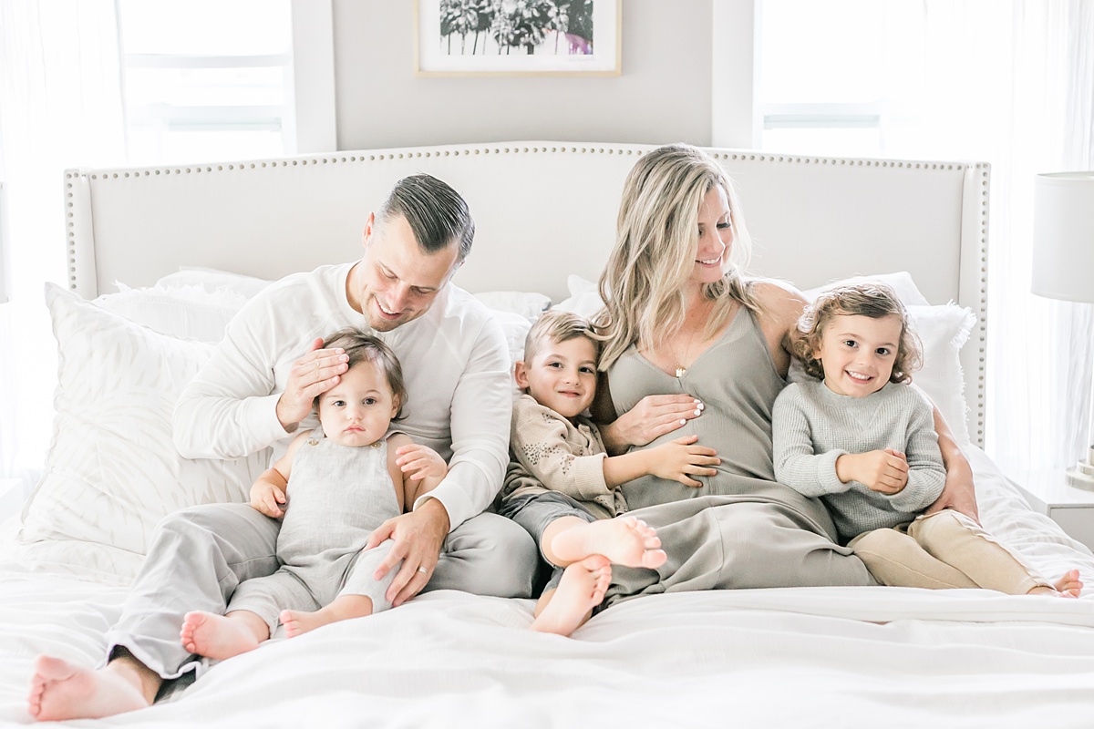 Family in bedroom during in-Home lifestyle maternity session by Charleston Maternity Photographer, Caitlyn Motycka Photography