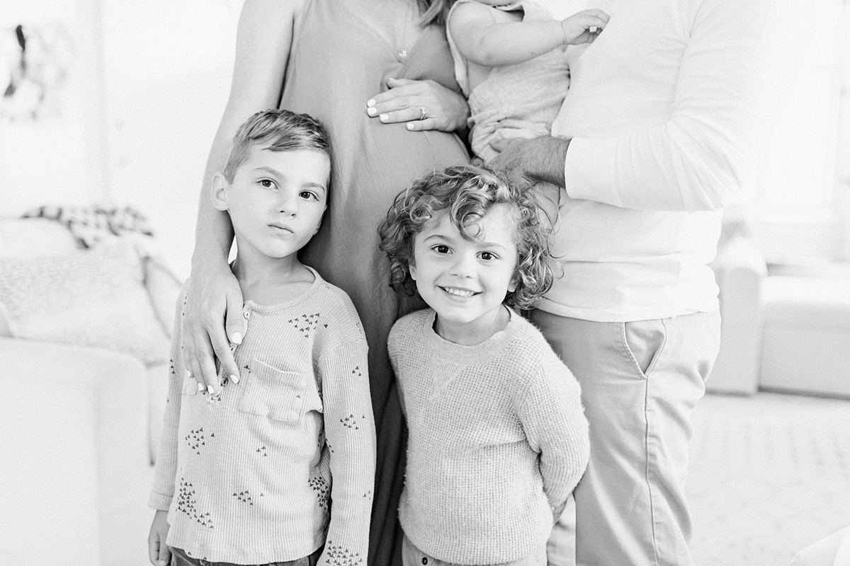 Black and white image of family from in-home lifestyle maternity session | Caitlyn Motycka Photography