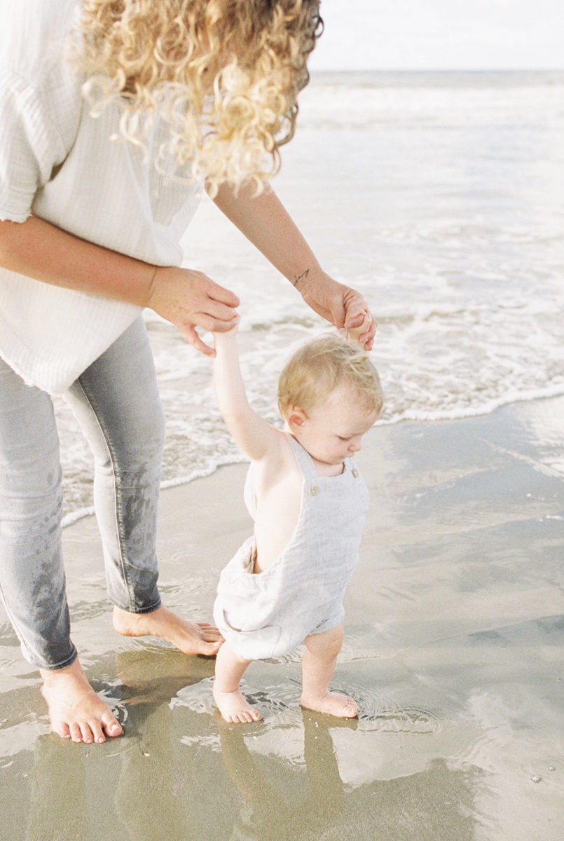 Baby playing in the water during sunrise photoshoot on Folly Beach | Caitlyn Motycka Photography