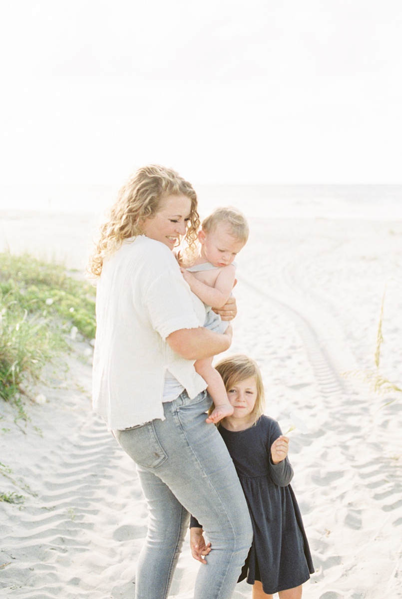 Mama with her littles during family photoshoot on Folly Beach. Photos by Charleston Film Photographer, Caitlyn Motycka Photography.